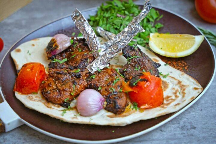 A plate with a flatbread with meat and vegetables